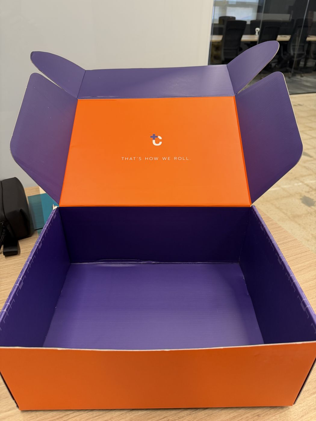 Prototype of the plum and orange mailer box, lid open